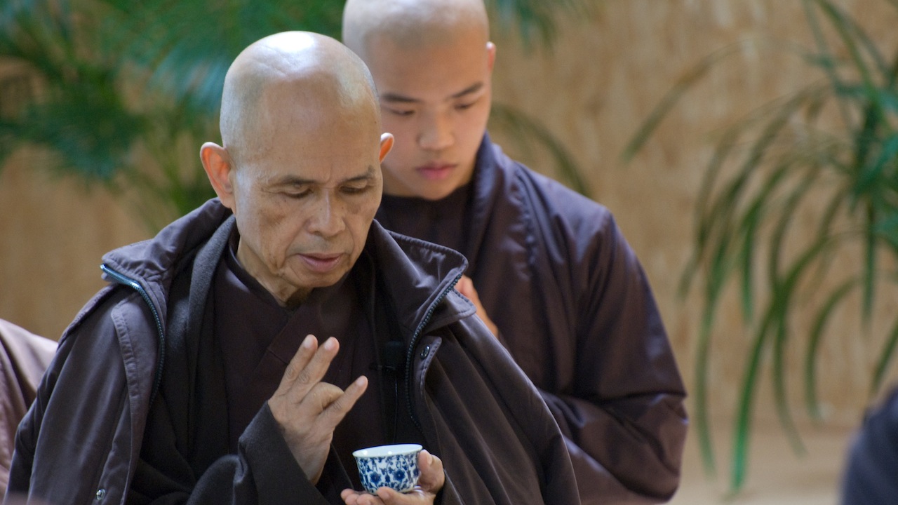 Thich Nhất Hanh with mudra and teacup